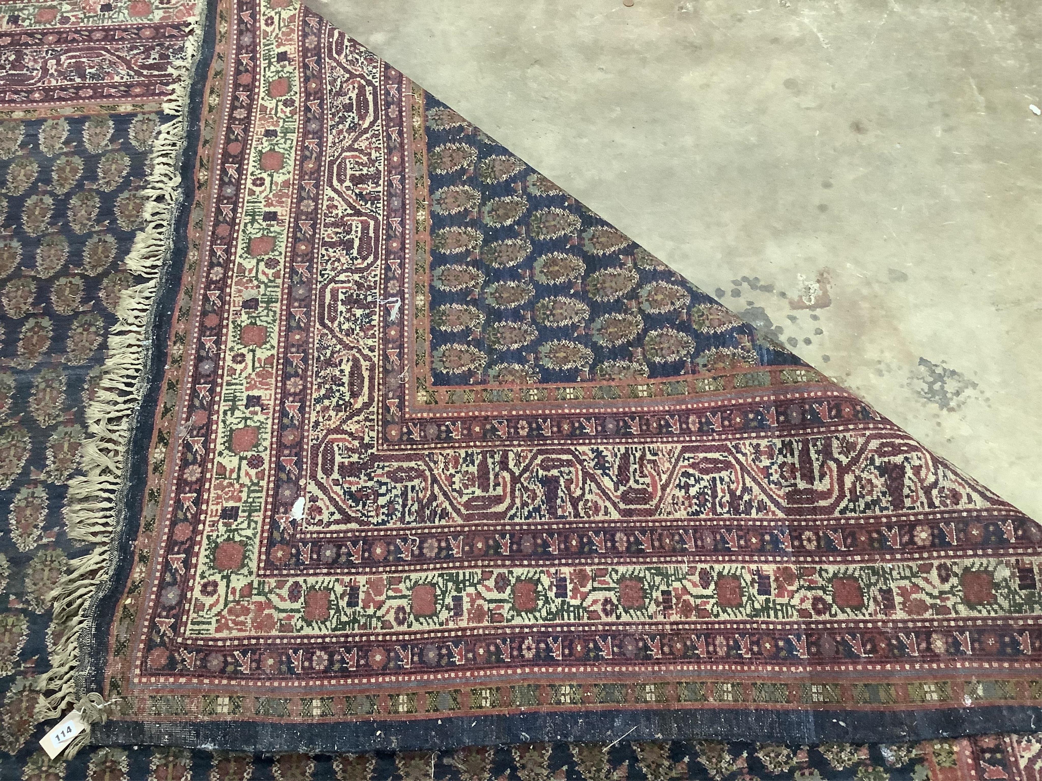 A Serabend blue ground boteh carpet, approximately 406 x 334cm. Condition - poor